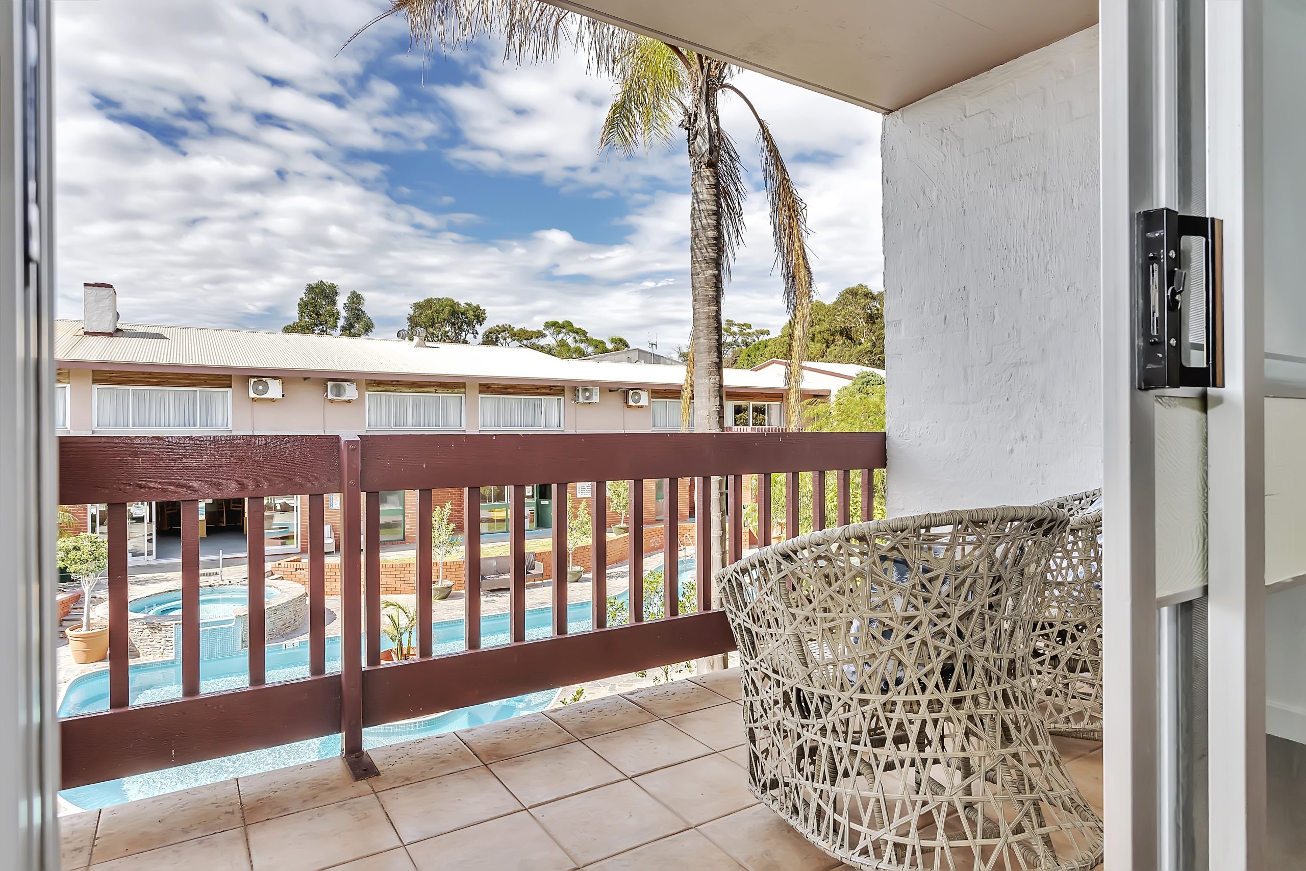 Hotel room with balcony overlooking the outdoor pool at Wirrina Cove Resort